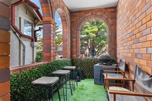 Relax in an outdoor space with comfortable seating and a grill for casual dining or barbecuing.