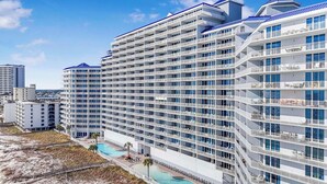 A multi-story hotel with balconies, a swimming pool, and a beach view. - 🌴Lighthouse 914: Beachfront Condo w/ Large Balcony & Gulf Views🌴 (Gulf Shores)