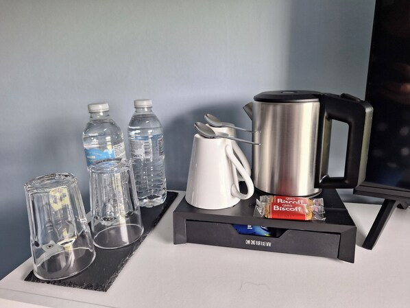 A coffee station with a coffee maker, two water bottles, and two glasses on a tray. - Room-ensuite Double Room With Countrysid (Cranleigh)