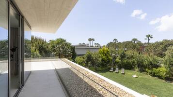 Enjoy a serene view of the lush garden from this outdoor balcony.
