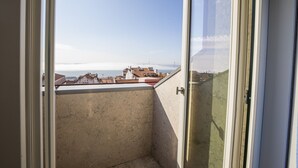 A balcony with a view of buildings and a bridge in the distance. - Chiado Rooftop Apartment by Cadenzalux (Lisbon)