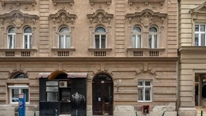 A historic building with ornate architectural details, including arched windows and decorative moldings. - Dessewffy Premium Apartment (Budapest)