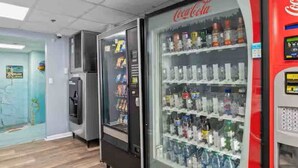 A vending machine area with Coca-Cola and other beverage options.