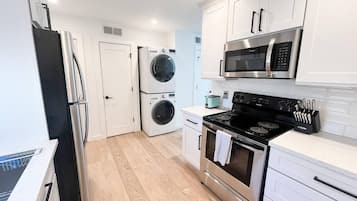 Fridge, coffee/tea maker, cookware/dishes/utensils, spices