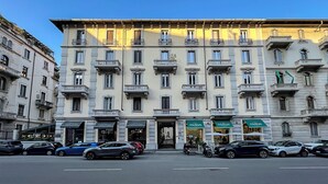 A multi-story building with a classic architectural style, featuring balconies and large windows. - Pliny Suite 33 -N.7- (Milano)