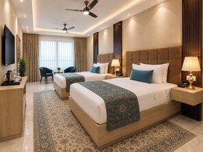 A hotel room with two beds, a TV, a desk, and a chair. - Hotel West End Mahipalpur Delhi IGI (New Delhi)