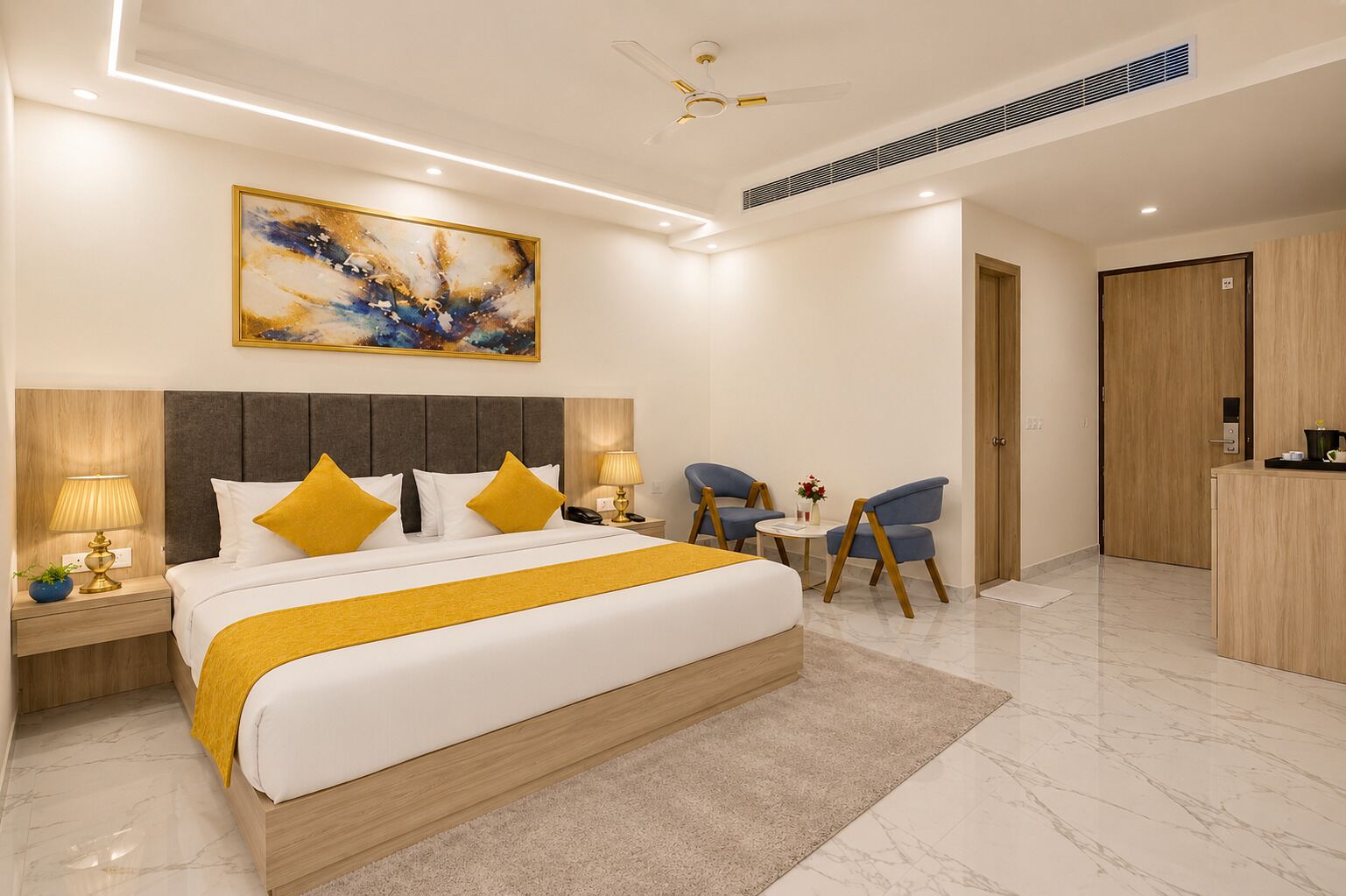 A modern hotel room with a large bed, bedside tables, a desk, and a chair.