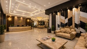 A hotel lobby with a reception desk, plush seating, and a chandelier. - Hotel West End Mahipalpur Delhi IGI (New Delhi)