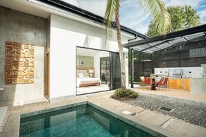 A modern house with a swimming pool, a kitchen, and a bedroom.