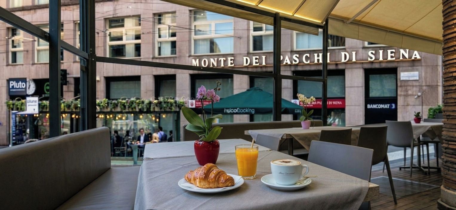 An outdoor café with tables, chairs, a croissant, a cup of coffee, and a glass of orange juice.