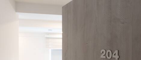 A room with a wooden wall and a number '204' indicating the room number.