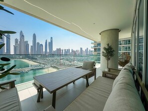 A balcony with a view of a city skyline and a marina. - Glamorous 3BR With Marina View (Dubai)