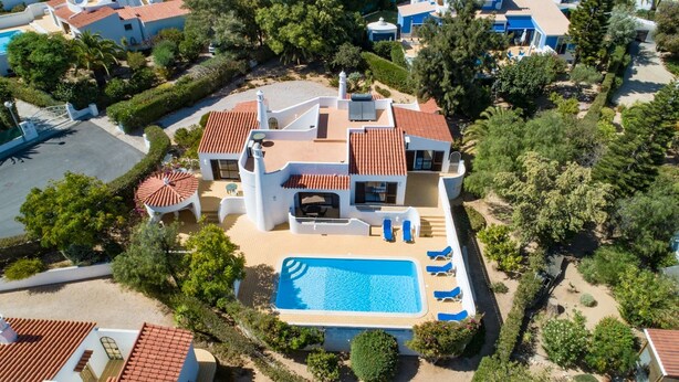 A modern villa with a swimming pool, multiple balconies, and a well-maintained garden. - Carosim Quiet Location Close to Beach Private (Lagoa)