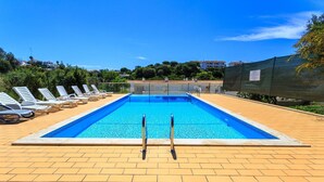A rectangular swimming pool with a clear blue water surface, surrounded by a tiled deck. - Outra Vez Spacious Apartment 5 Minute Walk From (Lagoa)