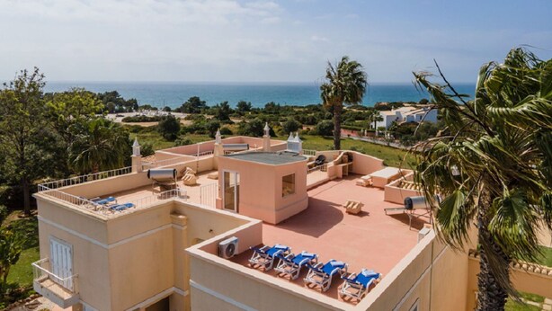 A rooftop terrace with lounge chairs and a view of the sea. - 11 Marinha Two Bedroom Apt at Praia do Marinha (Lagoa)