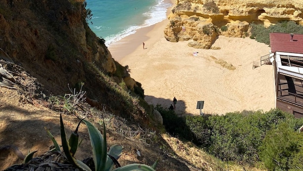 A coastal landscape with cliffs, a beach, and a building with a red roof. - 10 Marinha Two Bed Apt At Award Wining Beach (Lagoa)