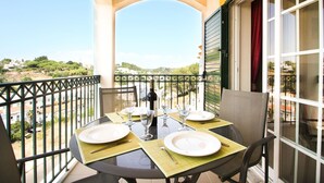 A balcony with a table set for four, overlooking a scenic landscape. - Lily Fabulous 1 BED APT With Roof Terrace Pool (Lagoa)
