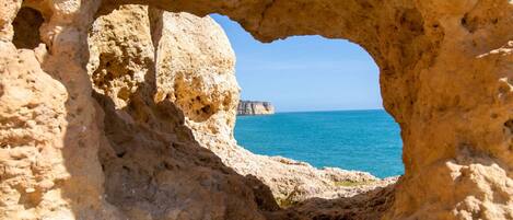A natural rock formation with a cave-like opening.