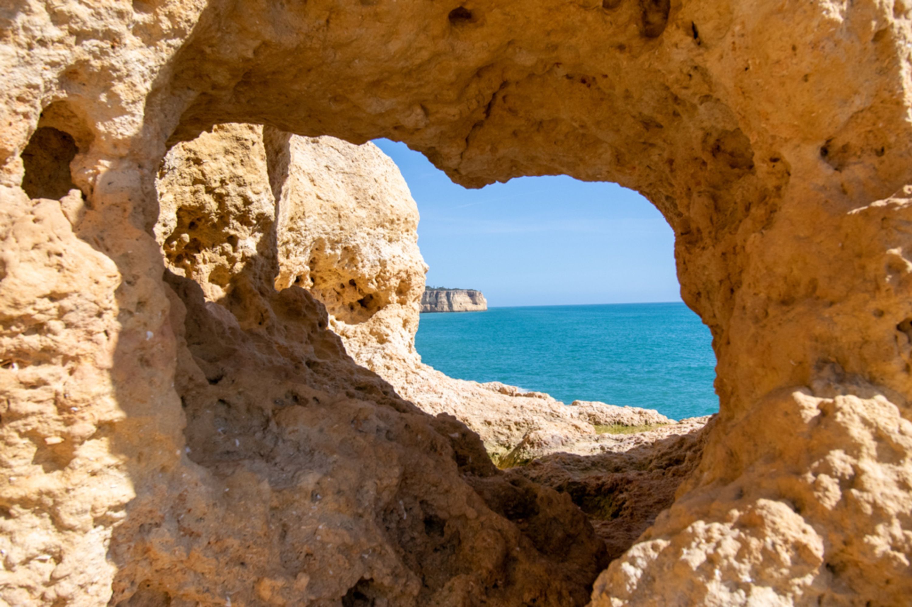 A natural rock formation with a cave-like opening.