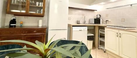 A compact kitchen with a microwave, toaster, and a small sink.