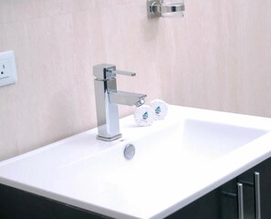 Bathtub, towels, soap, toilet paper