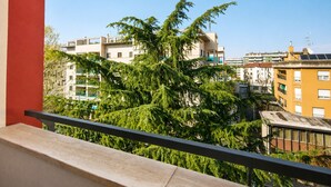 A balcony with a view of residential buildings and trees. - New Pop Art Suit with Parking (Unknown)