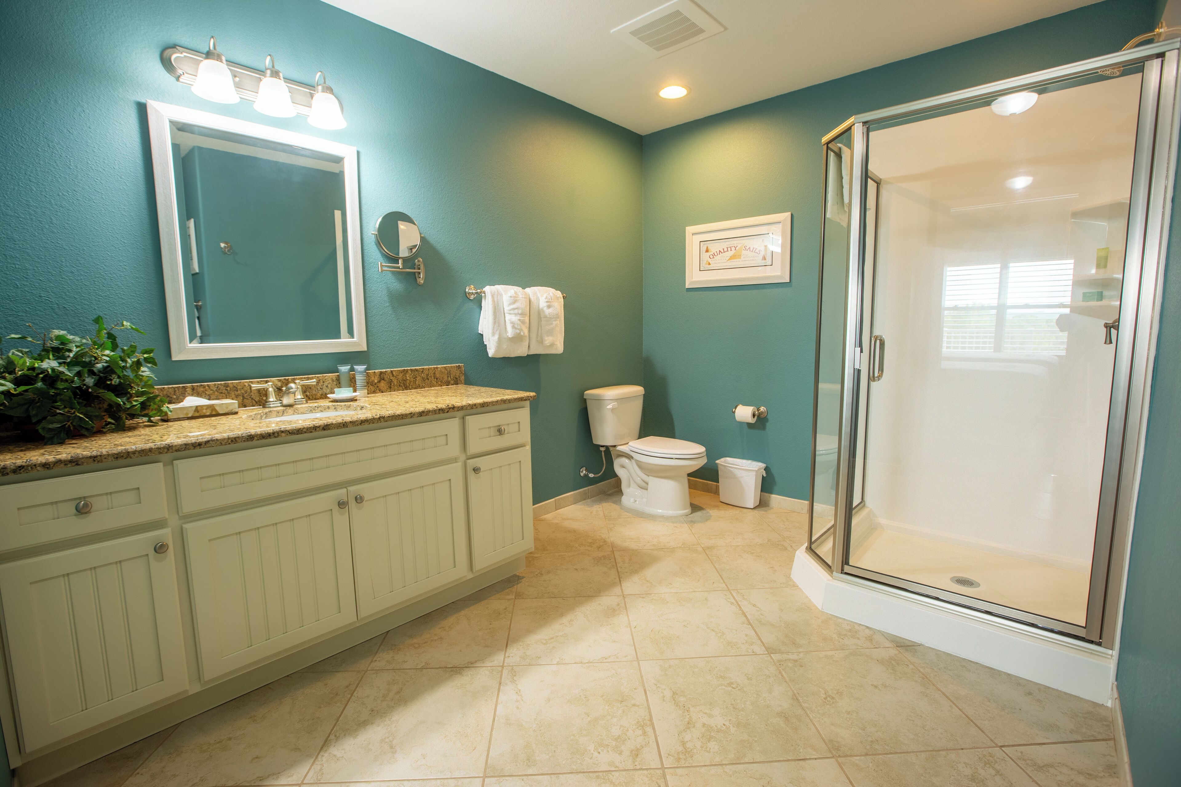 A bathroom with a shower, toilet, and sink.