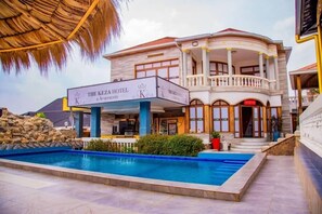 The Keza Hotel with a swimming pool, a covered outdoor area, and a two-story building with a balcony. - The Keza Hotel (Kigali)