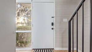 A white door with a black handle, a glass door, and a black metal railing. - New-heatherbrae 8-old Town-camelback View (Scottsdale)