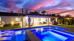 A modern house with a pool, outdoor seating, and a staircase leading to a balcony. - NEW Sundancer Oasis Old Town Pool Spa Rooftop Deck (Scottsdale)