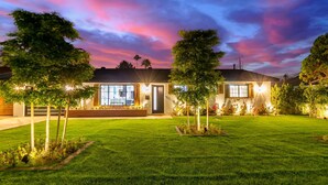 A modern house with a well-maintained lawn and a large window overlooking the front yard. - NEW Sundancer Oasis Old Town Pool Spa Rooftop Deck (Scottsdale)