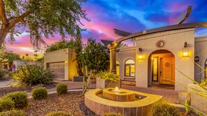 A modern building with a courtyard, a fountain, and a sunset sky. - NEW Parkwood Retreat w Pool Spa Kierland (Scottsdale)