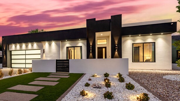 A modern house with a garage, a well-lit entrance, and a landscaped garden with stepping stones and lights. - The Carlisle Experience 4 Showers Heated Pool (Scottsdale)