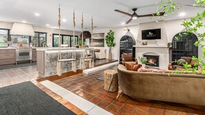 A spacious living area with a fireplace, a large sofa, and a hanging swing.