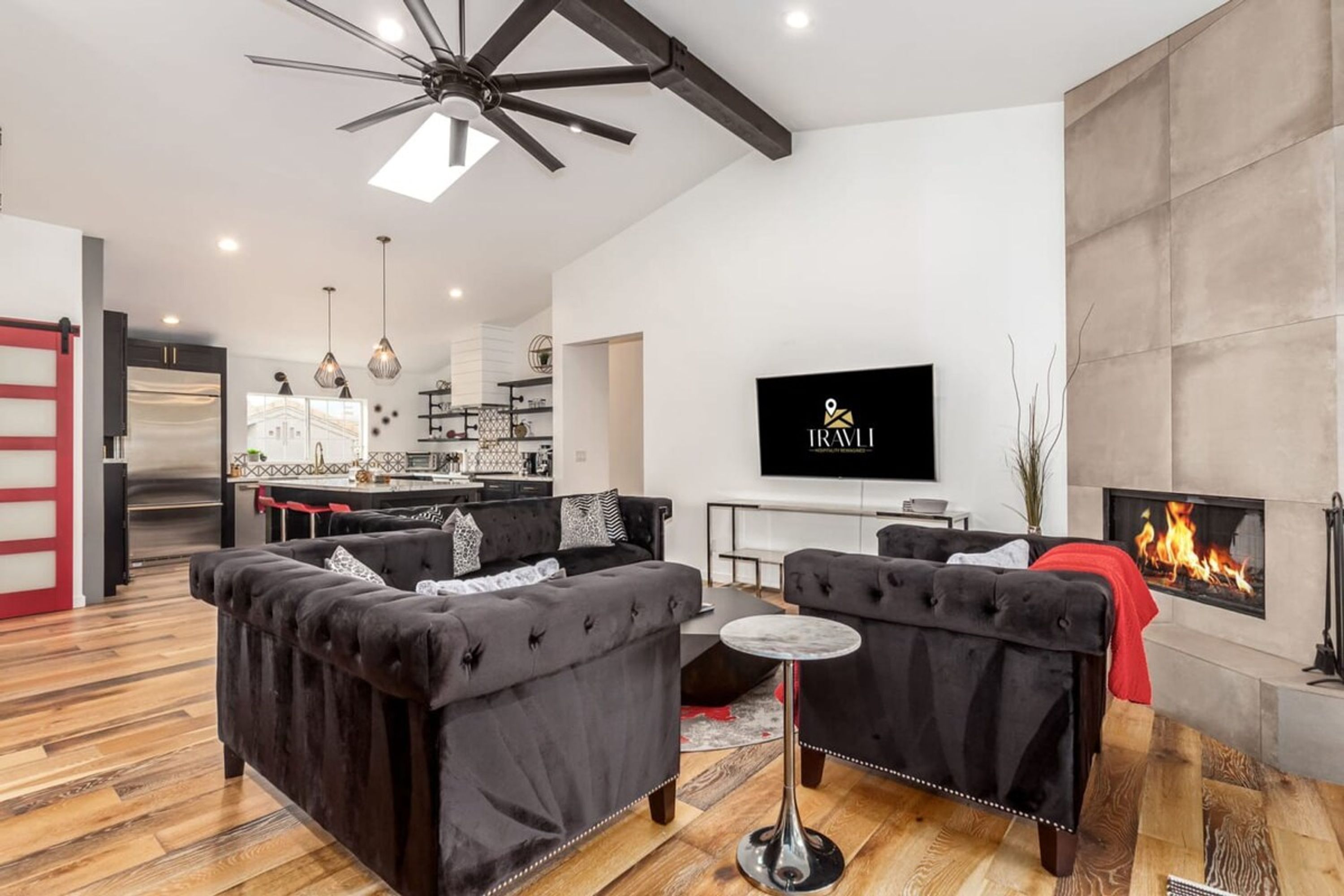 A modern living room with a fireplace, a television, and a dining area.