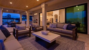An outdoor living area with a sofa, chairs, and a coffee table. - Sweetwater Resort Estate Tennis Pool Spa Vball (Scottsdale)