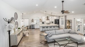 A modern kitchen with a central island, bar stools, and pendant lighting. - 5BR Citrus Estate Sleeps 13 Free Htd Pool Gameroom (Mesa)