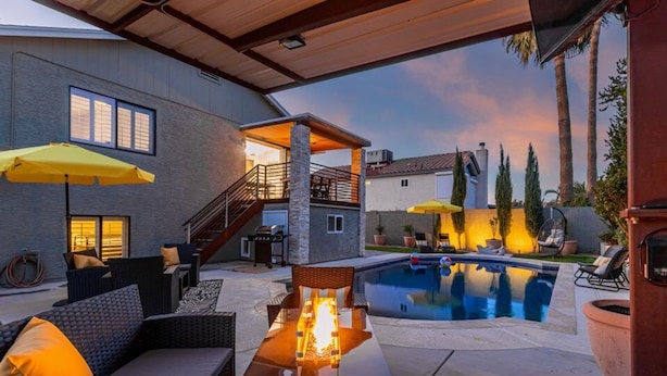 An outdoor patio area with a pool, seating, and a fire feature. - Princess Retreat Private Pool Firepit Sleeps 12 (Mesa)