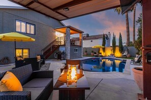 An outdoor patio area with a pool, seating, and a fire feature. - Princess Retreat Private Pool Firepit Sleeps 12 (Mesa)