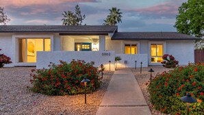 A modern two-story house with a number '5902' displayed on the front wall. - Corrine Family Oasis Pool Putt Grn Bigtoy (Scottsdale)