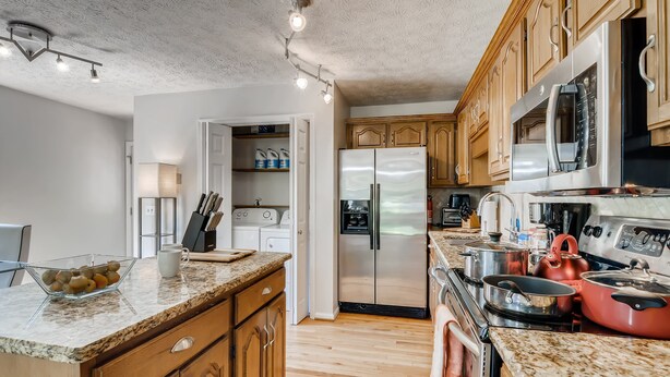 A modern kitchen with wooden cabinets, stainless steel appliances, and a granite countertop. - 3BR 2bath Gorgeous Country Near Nashville F1 (Franklin)