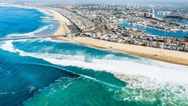 An aerial view of a coastal city with a beach, marina, and densely packed buildings. - Costa Mesa -newport- Patio - Free Parking-cm-2 (Costa Mesa)