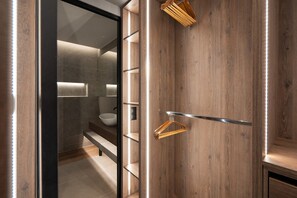 A modern bathroom with a wooden wall, a hanging towel rack, and a glass shower enclosure. - LIV - Modern Heavenly Retreat in Exarcheia (Athens)