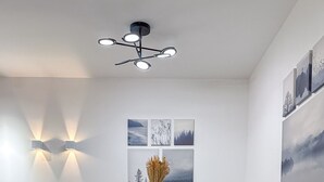A modern dining area with a glass table, grey upholstered chairs, a wooden base, and a vase with dried plants. - LIV - Modern Comfort Oasis in Pagrati (Kaisariani)