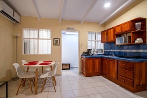 Apartment, Multiple Beds, Patio, Garden View (Villas Paraiso B52) | Private kitchen | Fridge, microwave, stovetop, cookware/dishes/utensils