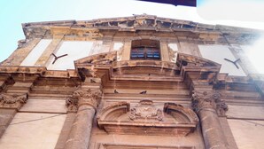 A historic building with a large green door and ornate architectural details.