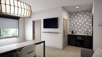 Um espaço de estar moderno e compacto, com área de jantar, cozinha compacta e uma janela grande que proporciona luz natural.