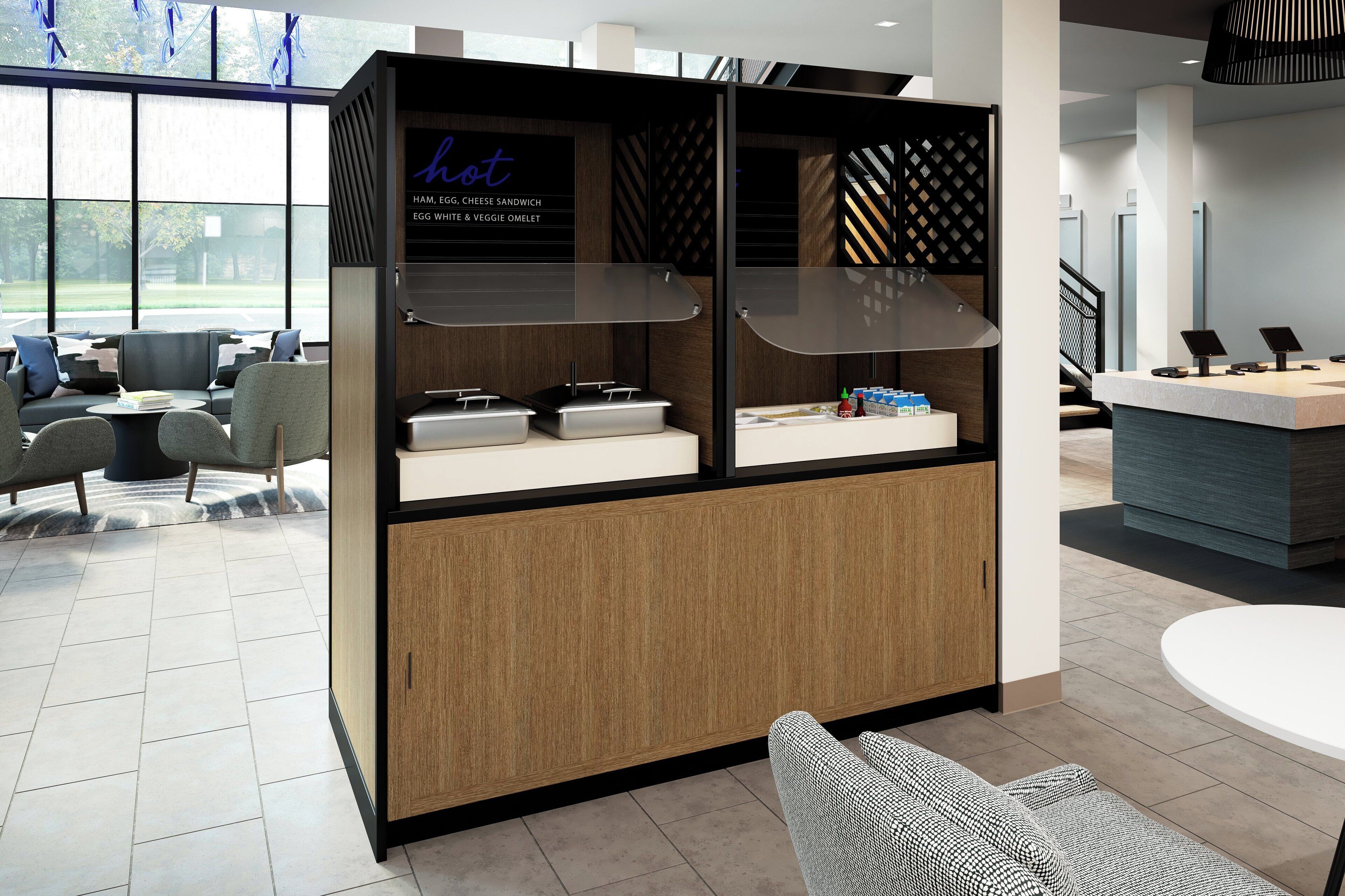 A modern hotel lobby with a reception desk, seating area, and a menu board displaying breakfast options.