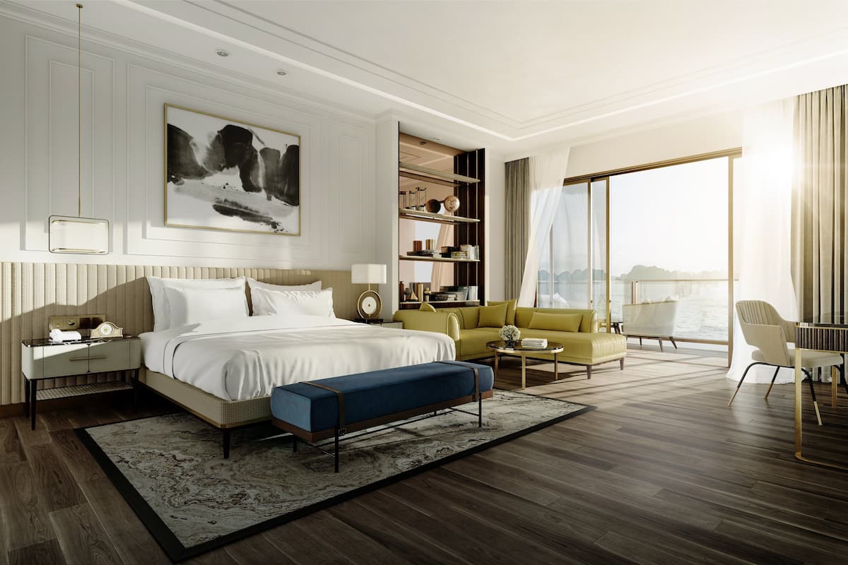 Enjoy a spacious room with a large bed, sofa, and dining table, plus a desk and bookshelf.