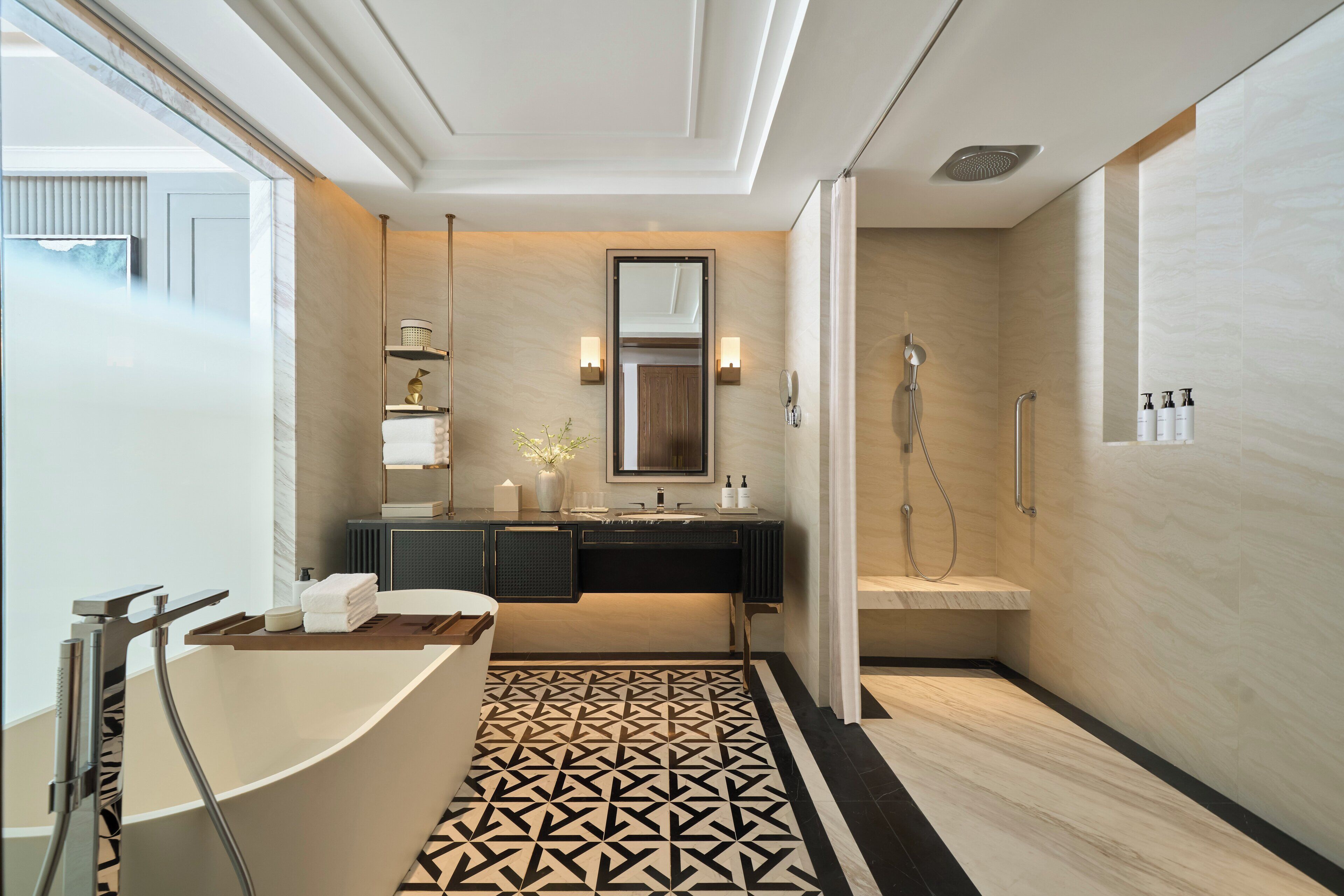 A modern bathroom with a freestanding bathtub, a walk-in shower, and a large mirror above the sink.